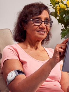 Woman with monitoring device on arm