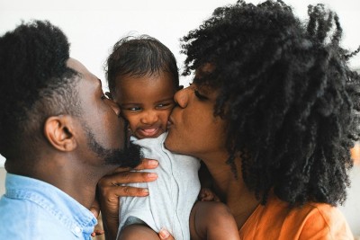 Couple kissing baby web.jpg